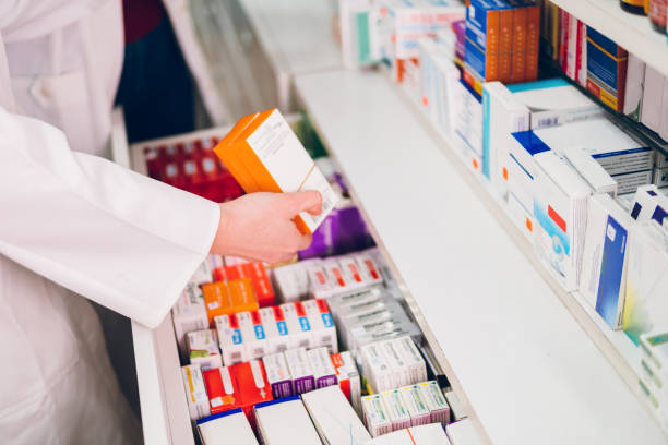 The pharmacist arranges the medicines in the pharmacy