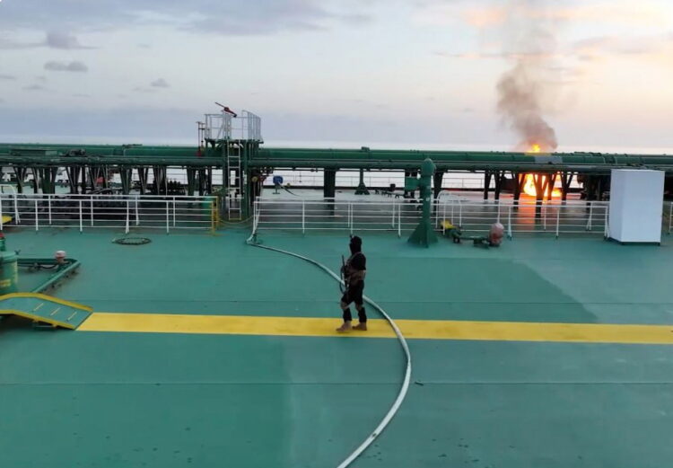 epa11572343 A handout photo made available by the Houthis media center shows a masked Houthi fighter with a rifle boarding the Greek-flagged oil tanker Sounion following Yemen's Houthis attacks, in the Red Sea, 29 August 2024. Yemen's Houthis have agreed to allow tugboats and rescue ships to access the damaged crude oil tanker Sounion in the Red Sea a week after they attacked it, according to a statement by Houthi spokesperson Muhammad Abdul-Salam. The Greek-flagged oil tanker Sounion, which has been on fire since 23 August in the Red Sea following Yemen's Houthis attacks, is still burning and it appears to be leaking oil, a US Pentagon spokesman said. Yemen's Houthis have claimed responsibility for a two-small boats and three projectiles attack against the oil tanker Sounion in the Red Sea off Yemen on 21 August 2024, Houthi military spokesman Yahya Sarea said in a statement.  EPA/HOUTHIS MEDIA CENTER HANDOUT -- BEST QUALITY AVAILABLE -- 

HANDOUT EDITORIAL USE ONLY/NO SALES